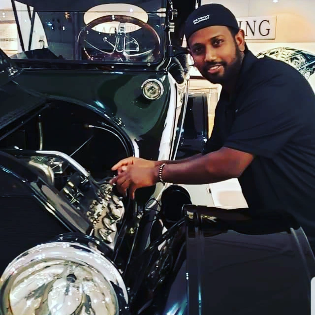 A technician performing an oil service at GB Auto Repair & Service
